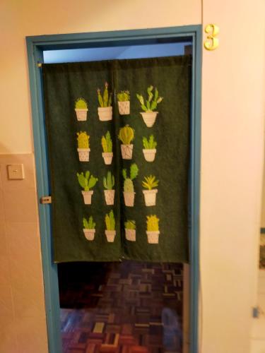 a door with a bunch of potted plants at R2L5Y Room 3 with aircond + TV( share Toilet only) in Bentong