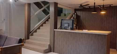 a room with a staircase with a tv on a counter at Hotel Turis in San Rafael