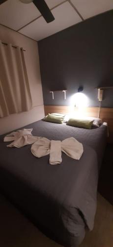 a bedroom with a bed with two towels on it at HOTEL TURIS Desayuno Incluido! in San Rafael