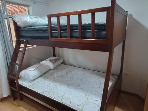 a bunk bed with a cushion on the bottom level at Elegante suite II in Cuenca