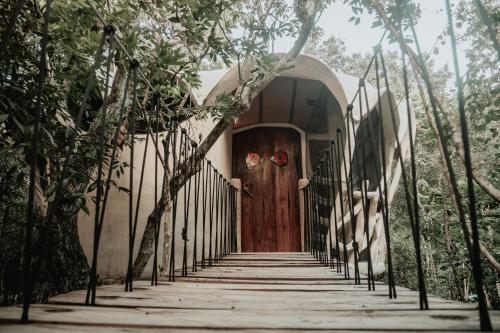 a front door of a house with a wooden door at Ikalar in Akumal
