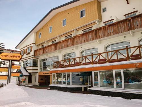 a large building with a balcony on top of it at ホテルサンモリッツ志賀 in Shiga Kogen