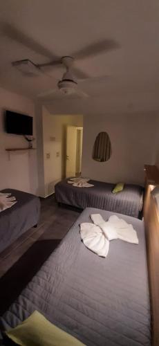 a hotel room with two beds with towels on them at HOTEL TURIS Desayuno Incluido! in San Rafael