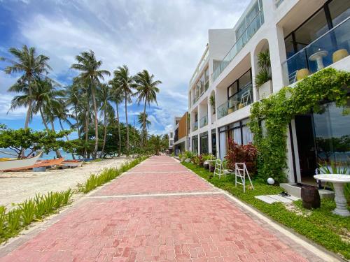 a red brick walkway in front of a building at Palassa Private Residences in Boracay