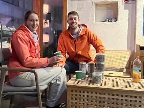 a man and a woman sitting at a table at Wally House青山惠风民宿 in Zhangjiajie