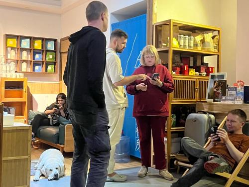 a group of people playing a video game in a room at Wally House青山惠风民宿 in Zhangjiajie