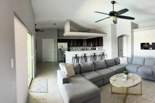 a living room with a couch and a table at Havasu Retreat! Pool, Spa, Gym & View in Lake Havasu City