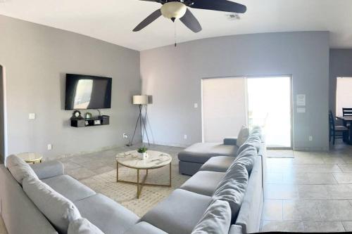 a living room with a couch and a ceiling fan at Havasu Retreat! Pool, Spa, Gym & View in Lake Havasu City