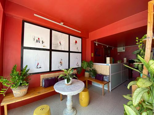 a room with red walls and a table with plants at Palassa Private Residences in Boracay