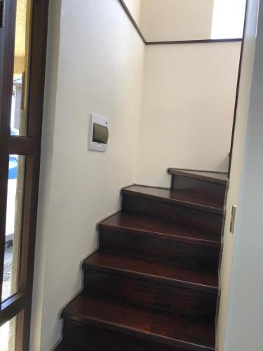 a set of stairs with a television on the wall at Casa en Condominio in Pucón