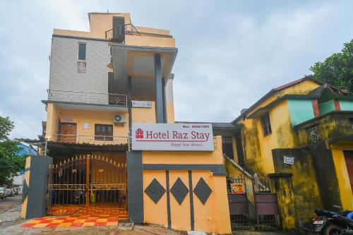 a building with a hotel rat stay sign on it at OYO Flagship 81152 Hotel Raz Stays in Bhubaneshwar