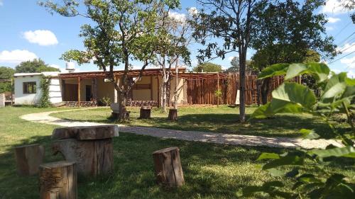 ein Haus mit einem Garten mit Bäumen und einem Zaun in der Unterkunft Angiru in Mercedes