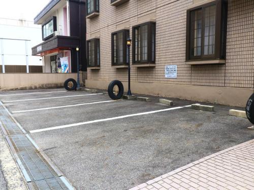 a parking lot in front of a building at Shinseto Station Hotel in Seto