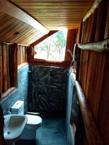 a small bathroom with a toilet and a window at Eco Creations Nuwaraeliya in Nuwara Eliya