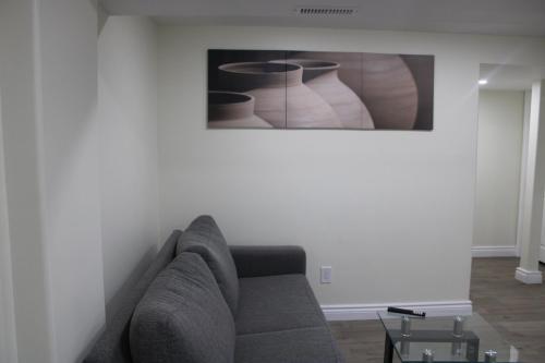 una sala de estar con sofá y una pintura en la pared en Comfyhome, en Vaughan