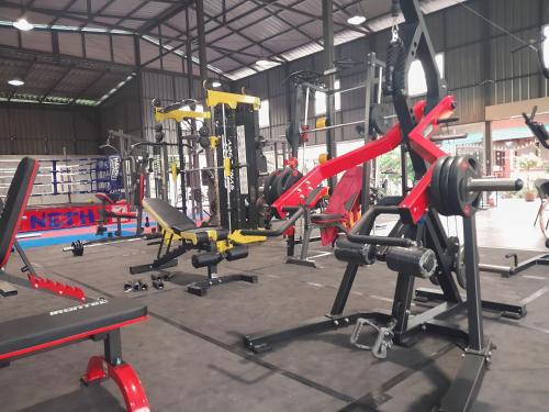 a gym with a bunch of machines in it at Thaineth Sport Camp in Nong Prue