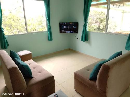 a living room with two couches and a tv at Casa de playa Briceño// Beach house Briceño in Briseño