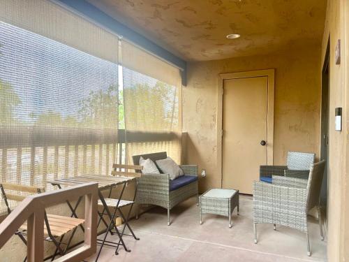 a balcony with a table and chairs and a window at Desert Getaway - Luxury Condo Loft in Chandler