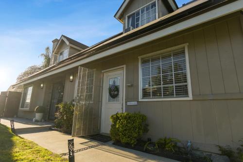 a house with a white door and a window at Luxury Cozy Studio with Firepit in Vista