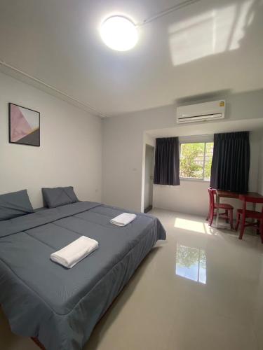 a bedroom with a bed and a table and chairs at ศิวพฤกษ์ เพลส in Nonthaburi