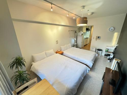 Postel nebo postele na pokoji v ubytování マルチステイ大阪天満