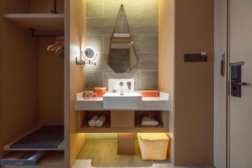 a bathroom with a sink and a mirror at Atour Hotel Xian Bell Tower Yongningli in Xi'an