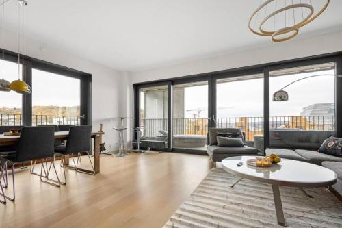 a living room with a couch and a table at Modern 3bed room sea view apartment @ Oslo Barcode in Oslo