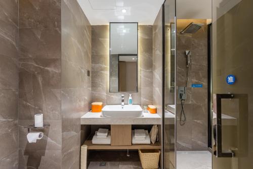 a bathroom with a sink and a shower at Atour X Hotel Xiamen Zhongshan Road Ferry Wharf in Xiamen