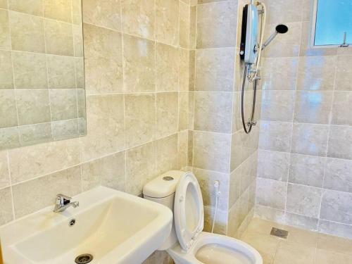 a bathroom with a shower and a toilet and a sink at 9 pax Homestay near Axiata Arena & Pavilion 2 in Kuala Lumpur