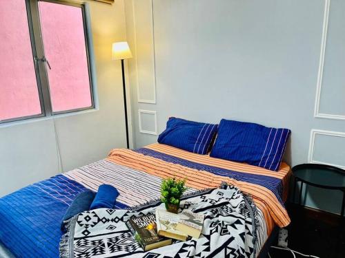クアラルンプールにある9 pax Homestay near Axiata Arena & Pavilion 2のベッドルーム1室(ベッド2台、テーブル、本付)