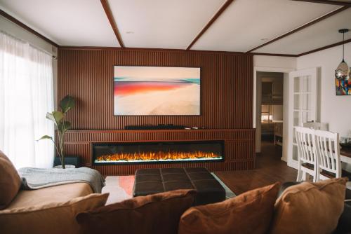 a living room with a couch and a fireplace at La Plage - A Cosy Cottage in Phillip Island in Cowes