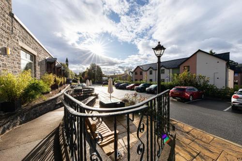 a fence with a bench on a city street at Scotland's Spa Hotel in Pitlochry