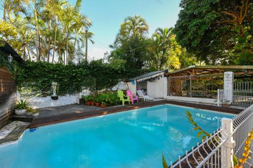 a swimming pool in a yard with a fence at LE MEDINILLA in Bras-Panon