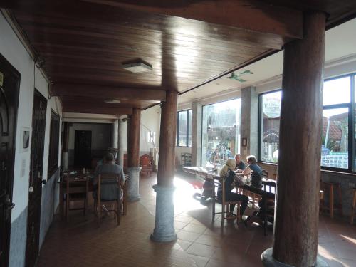 a group of people sitting at tables in a restaurant at Lacasa Vang Vieng Hotel in Vang Vieng