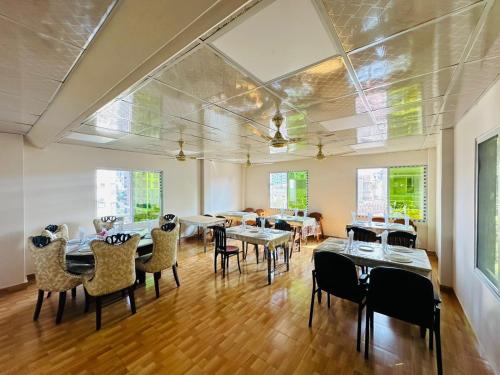 a large dining room with tables and chairs at Hotel Heaven Inn in Dhaka