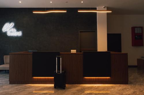 a lobby with a reception desk and a suitcase at Blu Sentral Hotel in Tawau