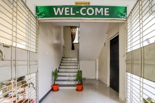 a hallway of a building with a well come sign at OYO SHRIDHAR CREATIVE Hotel & Restaurant in Nagpur