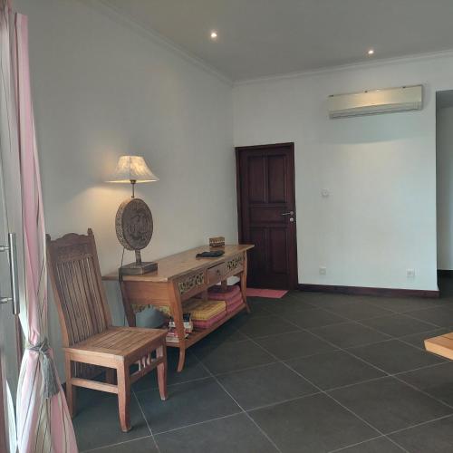 a room with a desk and a chair and a lamp at Lovina Paradise in Lovina