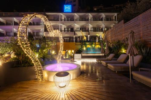 a courtyard with a fountain and a building at night at Hi Hotel - Wellness & Spa in Trento