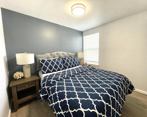 a bedroom with a bed with a blue and white comforter at Golden Gate Park Sweet Home-2 bedrooms in San Francisco