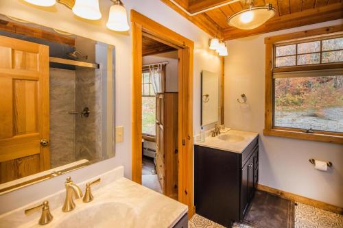 y baño con lavabo, ducha y espejo. en Viewmont Chalet, en Killington