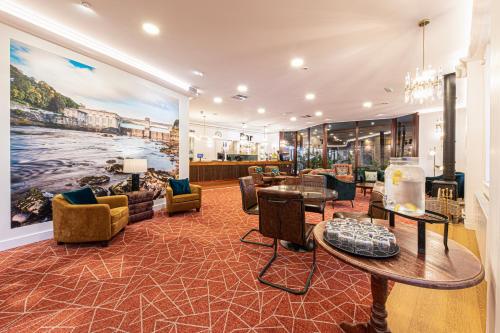 a living room with a large painting on the wall at Scotland's Spa Hotel in Pitlochry