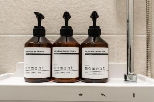 four bottles of honey sitting on a shelf at Radiant Nampo Hotel in Busan
