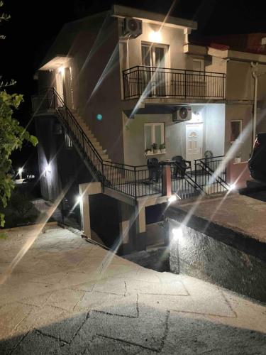 a building with a staircase in front of it at night at KM Apartments in Kotor