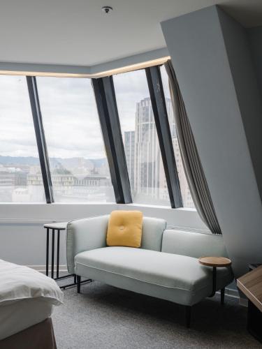 a couch in a room with a large window at Hotel attic in Taipei