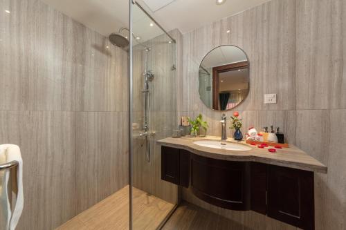 a bathroom with a sink and a shower at Hanoi Calista Hotel & Spa in Hanoi