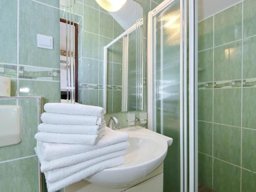 a white bathroom with a sink and a mirror at Holiday Home Maslenica with Sea Views & Pool in Maslenica