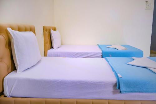 two beds sitting next to each other in a room at FabEscape Orient Royal in Calangute