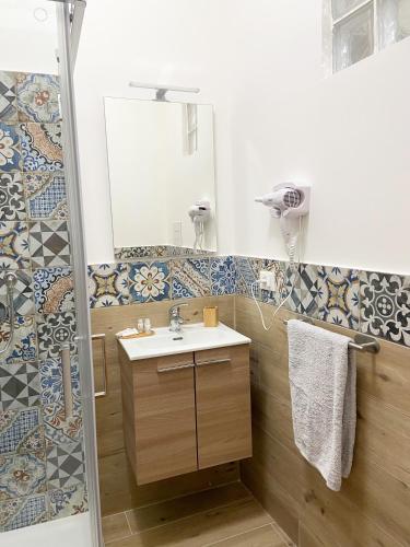 a bathroom with a sink and a shower at La casa di Angela in Monreale