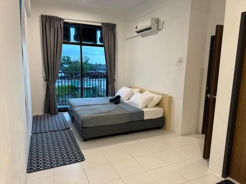 a bedroom with a bed and a window at SOFEA IMPERIO HOMESTAY @ ALOR SETAR in Alor Setar